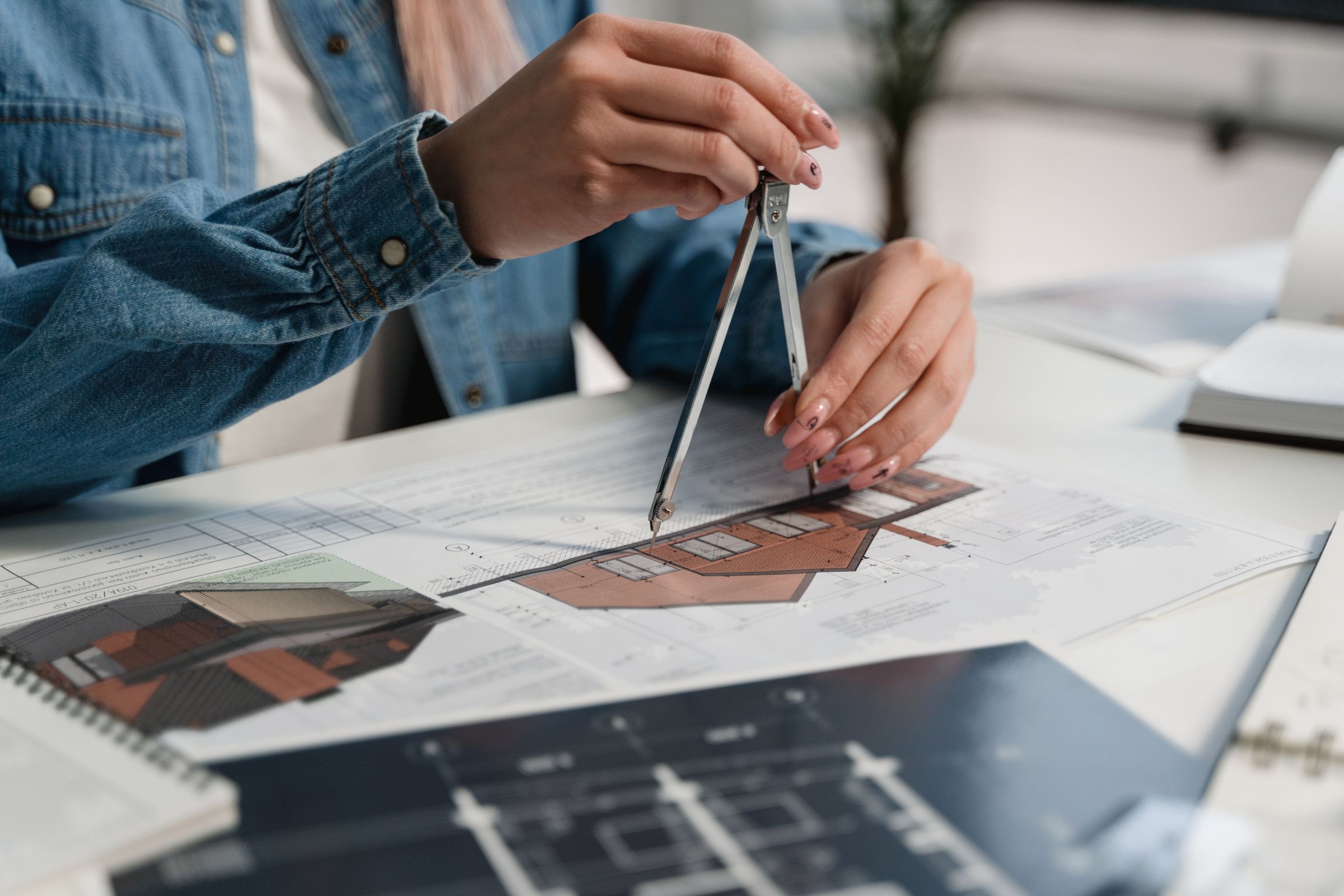 Site plans being measured at a desk